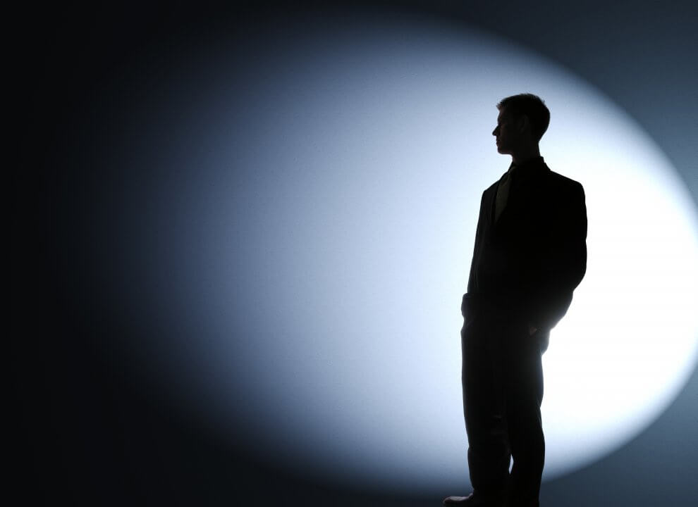 Businessman silhouetted in a spotlight